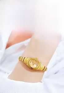 Macro detail of gold vintage quartz bracelet watch with sparkling diamond inlay