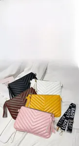 Dettaglio di borse trapuntate in cinque colori con nappe e tracolle con scritta logo