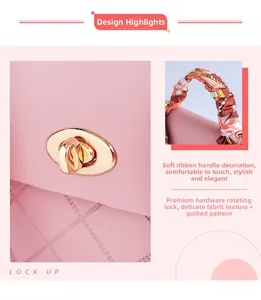 Detail of pink mini handbag featuring golden turn-lock and silk scarf-wrapped handle