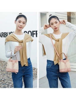 Detail of mini pink leather and beige straw bucket bag shown in handheld and crossbody styles