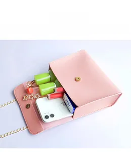 Internal view of pink leather bag showing storage for phone, lipstick and accessories