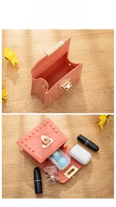 Detailed internal view of pink studded mini jelly bag showing lipstick and accessory storage