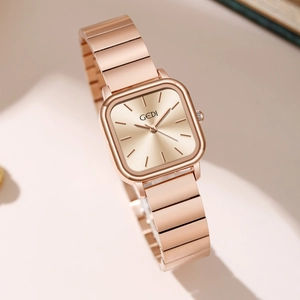 Minimalist square rose gold women's quartz watch with elegant mesh strap on stylish background
