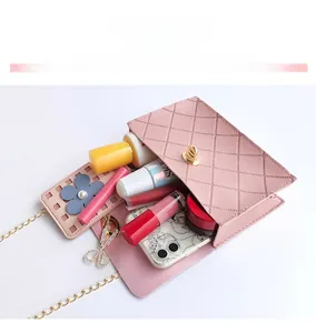 Pink quilted crossbody bag interior capacity showing storage for phone and lipstick