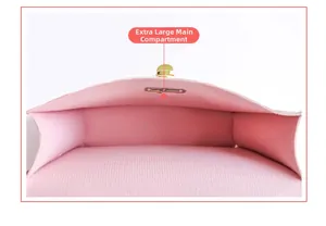Macro view of the pink handbag's large capacity main compartment and golden hardware