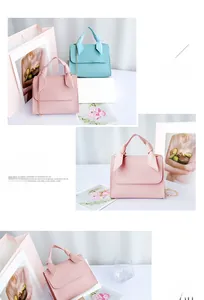 Detail showing mini pink and light blue handbags with knot handles and gold chain straps