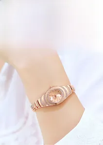Close-up of elegant rose gold bracelet watch with rhinestone-encrusted oval dial