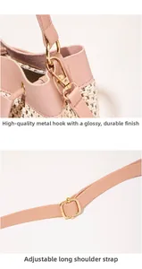 Detail of pink woven handbag featuring glossy gold metal clasp and adjustable strap