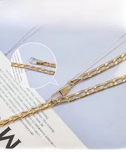 Detailed view of adjustable golden metal chain strap with lobster clasp for handbags