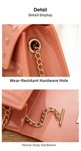 Macro detail of high-shine pink PVC jelly bag with gold rivets and metallic chain