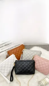 Detailed view of five quilted chain crossbody bags in black, white, pink, brown and grey