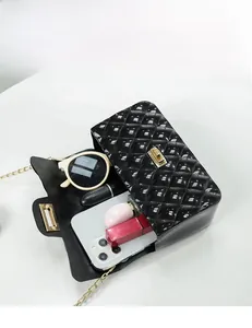 Detail showing the internal storage capacity of a black quilted jelly bag with essentials