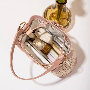 Pink leather bucket bag with woven straw texture and large interior storage capacity