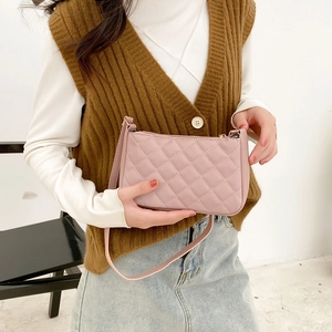 Pink quilted underarm bag with diamond stitching and slim shoulder strap for women