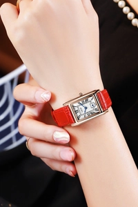 Detailed view of GEDI vintage square quartz watch with red leather strap on wrist
