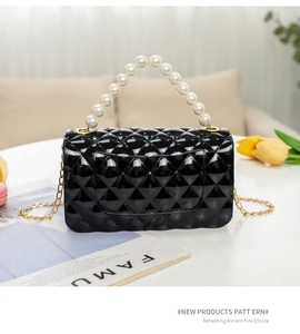 Detailed close-up of black quilted jelly bag with pearl handle and golden chain