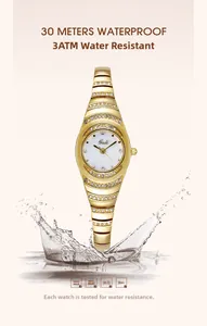 Macro shot of gold bracelet watch showing 3ATM water resistance with water splashes