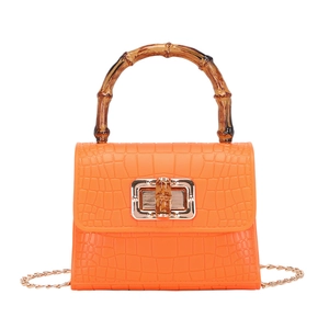 Orange crocodile-pattern mini bag with bamboo top handle and gold chain strap