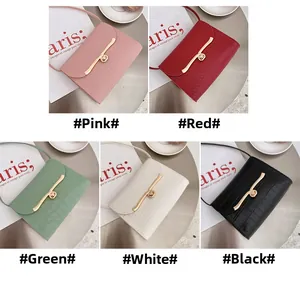 Mini crossbody bags with crocodile texture showing pink, red, green, white, and black colors