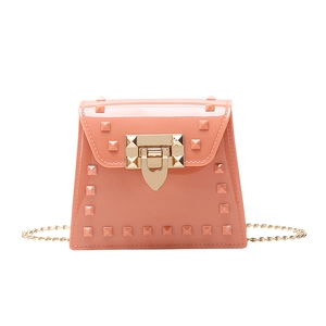 Coral orange PVC jelly handbag with rivet studs and golden chain strap in front view