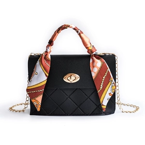 Black quilted mini handbag with gold chain strap and silk scarf wrapped handle
