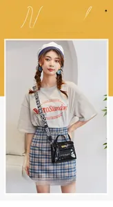 Glossy black Kelly style handbag with wide logo strap shown on female model
