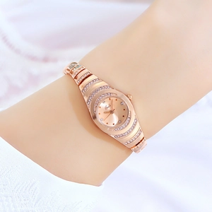 Elegant rose gold bracelet watch with rhinestone-encrusted case and gold sunray dial