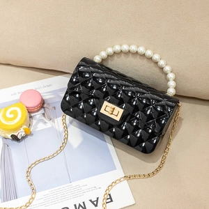 Elegant black quilted jelly bag with large pearl handle and gold chain strap for women