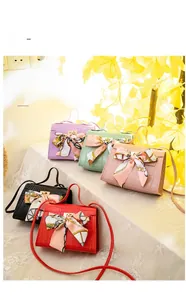Detail view of crocodile pattern mini handbags with silk scarf and adjustable strap