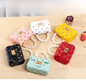 Macro detail of jelly handbags with quilted texture, sparkling rhinestones and pearl handles