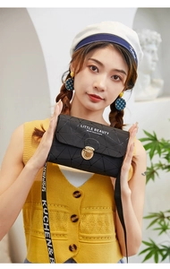 Detail of black geometric embossed mini crossbody bag with fashion letter wide strap