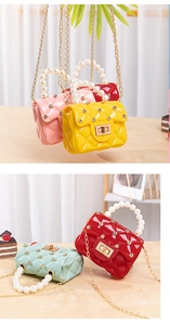 Close-up of diamond jelly bags with pearl handles and gold chains in assorted bright colors