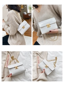 Detailed view of white crocodile pattern crossbody bag with golden square lock and chain