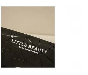 Detail of black geometric triangle pattern shoulder bag with Little Beauty lettering