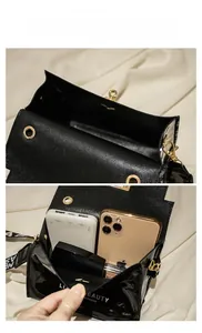 Interior storage capacity of the black patent leather bag for phone and cosmetics
