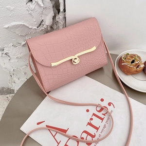 Elegant pink crocodile pattern mini crossbody bag with a gold buckle on white background