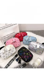 Detail of laser geometric handbags with bow zippers and New City logo webbing straps