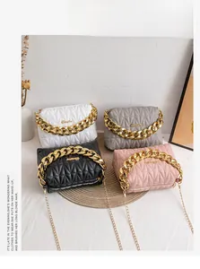 Detail of four quilted rhombic chain bags in white, grey, black, and pink colors