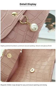 Detail of pink croc-embossed bag featuring polished hardware, pearl charm, and magnetic snap