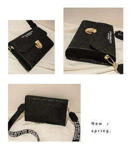 Detail view of black geometric crossbody bag with gold lock and printed fabric strap