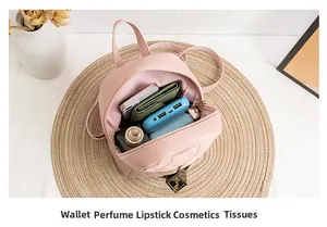 Pink quilted backpack interior showing space for wallet, perfume, and cosmetics