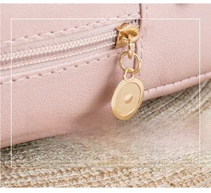 Detailed close-up of pink lychee textured leather backpack with gold metal zipper pull