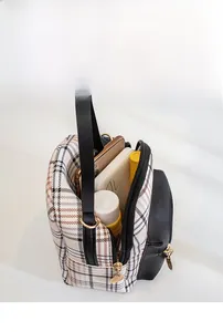 Top view of mini plaid backpack showing spacious interior for phone and cosmetics