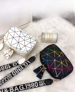 Detail of colorful geometric pattern crossbody bags with wide adjustable logo straps