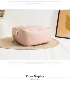 Detailed view of pink quilted leather bag with golden zippers and round charms