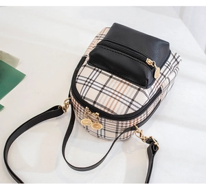 Detailed view of mini crossbody bag featuring contrast plaid pattern and gold hardware