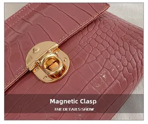 Close-up of pink croc-effect leather texture and gold magnetic closure on mini bag