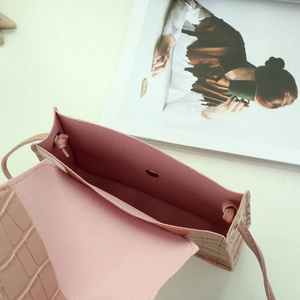 Pink mini crocodile pattern crossbody bag with pearl strap and internal magnetic snap
