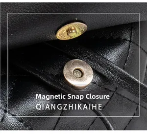 Detail of golden magnetic clasp on quilted black leather backpack for women
