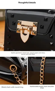 Detailed view of black patent leather crossbody bag with gold studs and metal chain strap